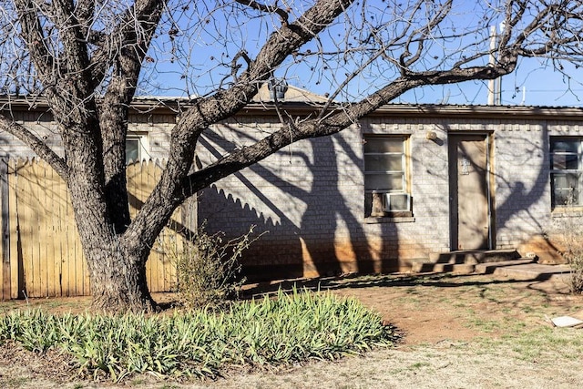 view of property exterior with entry steps and brick siding