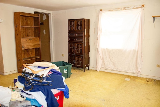 bedroom with carpet floors and baseboards