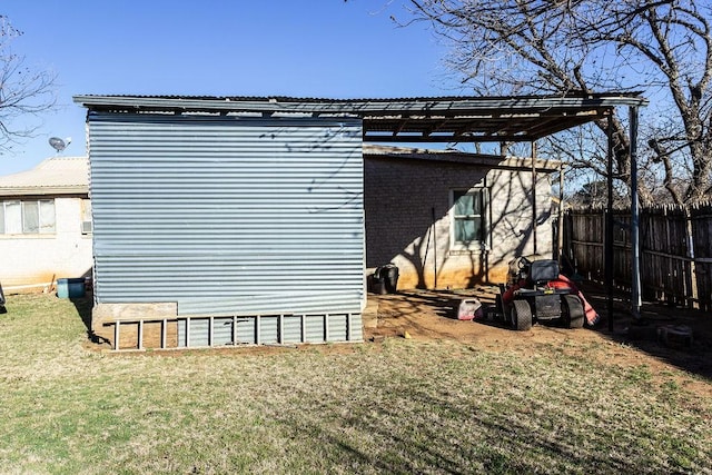 view of outbuilding featuring fence