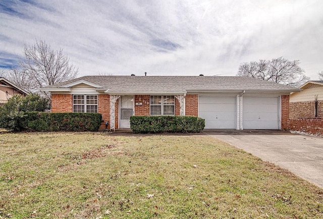 ranch-style house with a front yard, concrete driveway, and brick siding