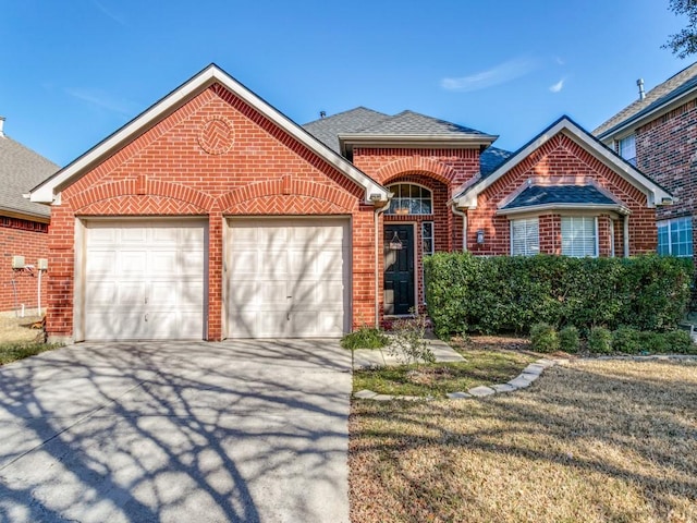 view of front of home featuring a garage, driveway, brick siding, and roof with shingles