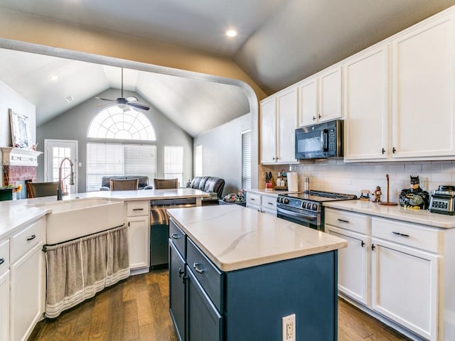 kitchen with open floor plan, stainless steel appliances, a ceiling fan, and white cabinetry