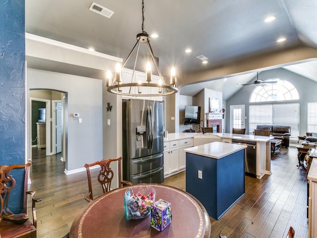 kitchen with light countertops, visible vents, appliances with stainless steel finishes, open floor plan, and a kitchen island