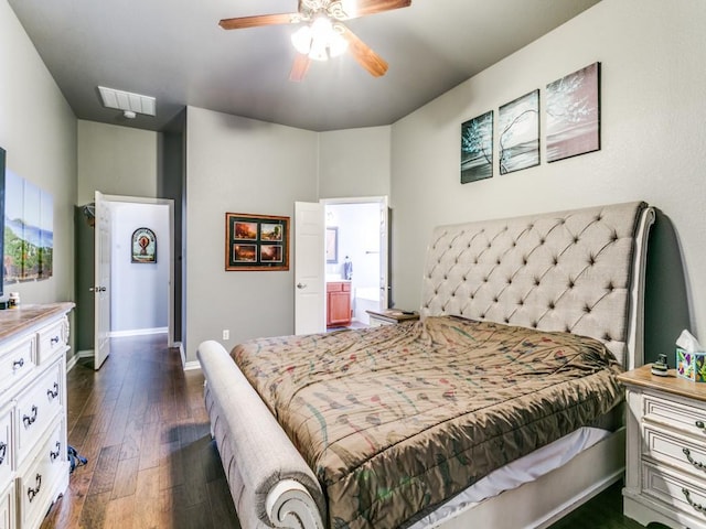 bedroom with ceiling fan, connected bathroom, visible vents, baseboards, and dark wood finished floors