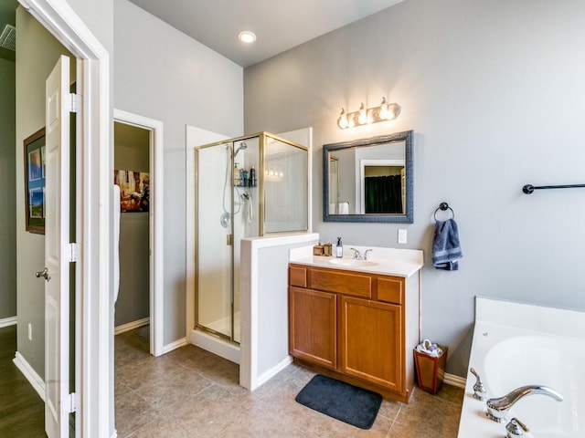 bathroom with a bath, a shower stall, vanity, and tile patterned floors