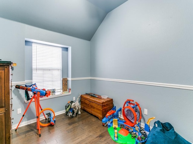 game room featuring baseboards, vaulted ceiling, and wood finished floors