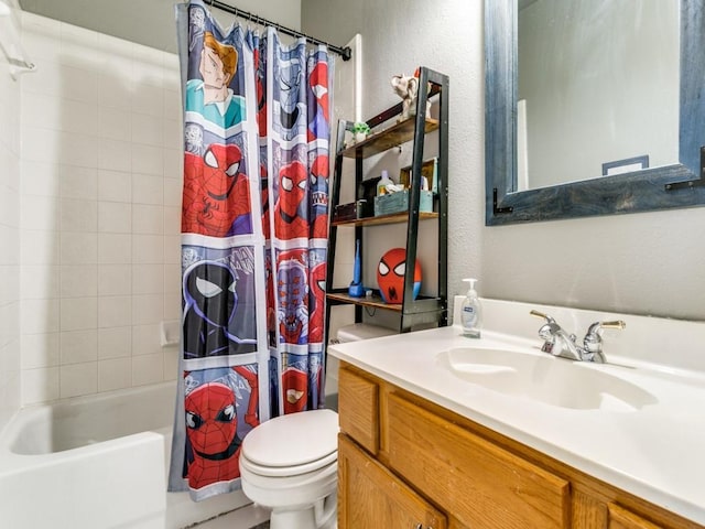 bathroom with a textured wall, shower / tub combo with curtain, vanity, and toilet