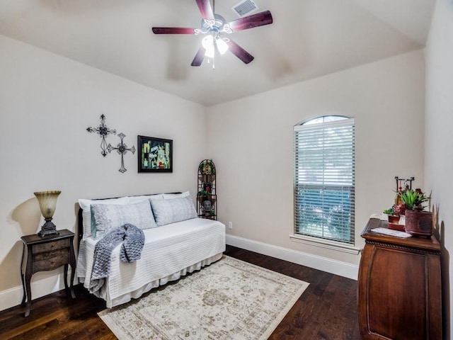 bedroom featuring a ceiling fan, baseboards, visible vents, and dark wood-style flooring