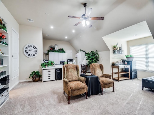 sitting room with light carpet, a ceiling fan, visible vents, vaulted ceiling, and baseboards