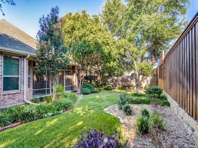 view of yard with a fenced backyard and a sunroom