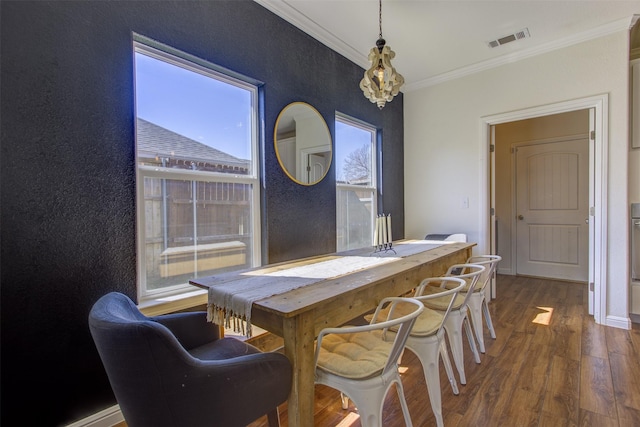 dining space featuring ornamental molding, visible vents, baseboards, and wood finished floors