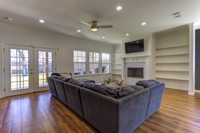 living room featuring plenty of natural light, visible vents, dark wood finished floors, and french doors