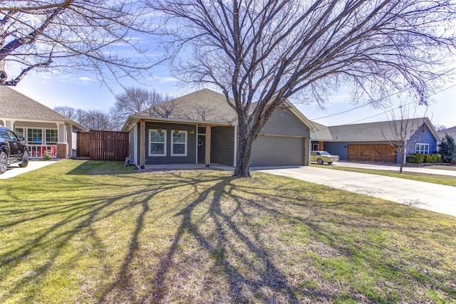 view of front facade featuring a front lawn, concrete driveway, fence, and an attached garage