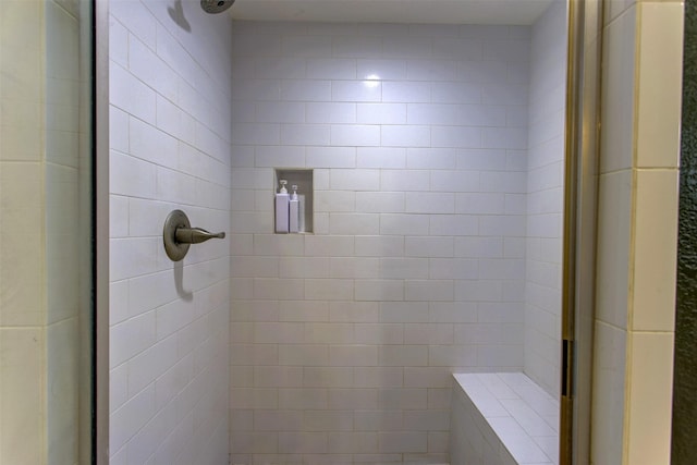 bathroom with a tile shower