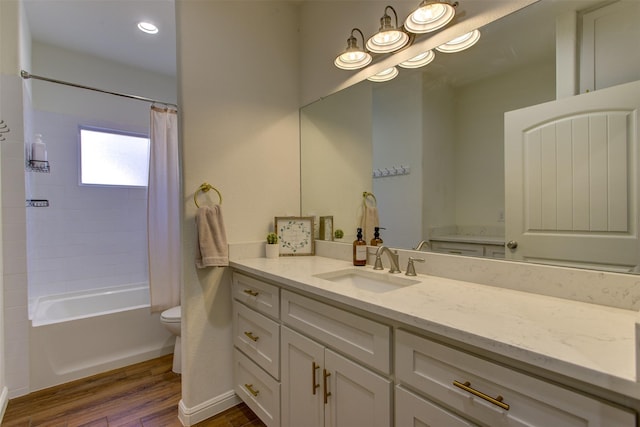 full bath featuring toilet, shower / bath combination with curtain, wood finished floors, and vanity