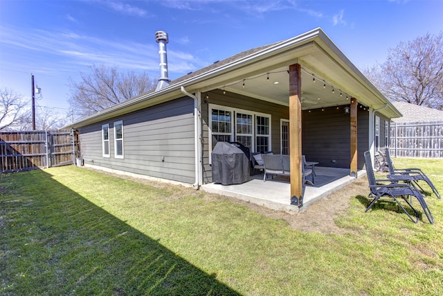 back of house featuring a yard, fence, and a patio