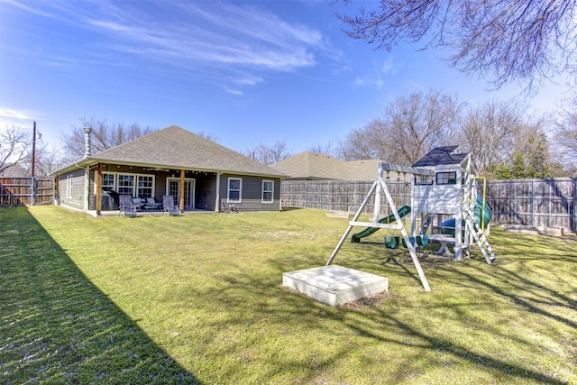 view of yard with a playground, a patio, and a fenced backyard