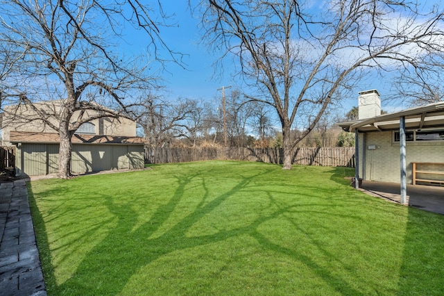 view of yard featuring an outdoor structure and a fenced backyard