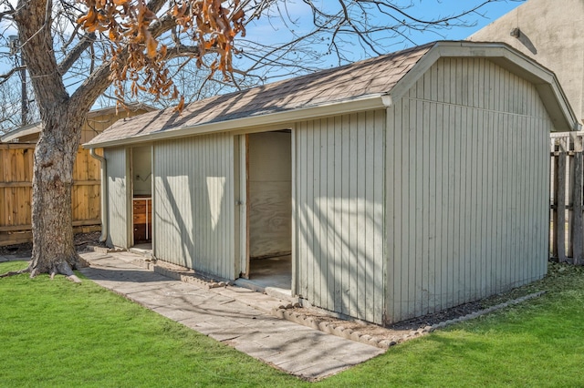 view of outbuilding with fence and an outdoor structure