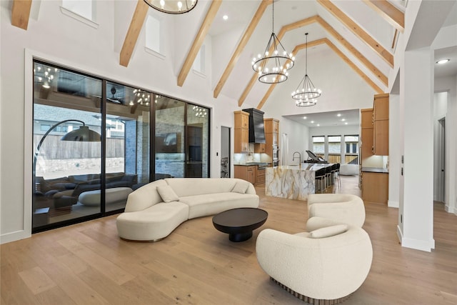 living room featuring baseboards, light wood-style flooring, a notable chandelier, high vaulted ceiling, and beam ceiling