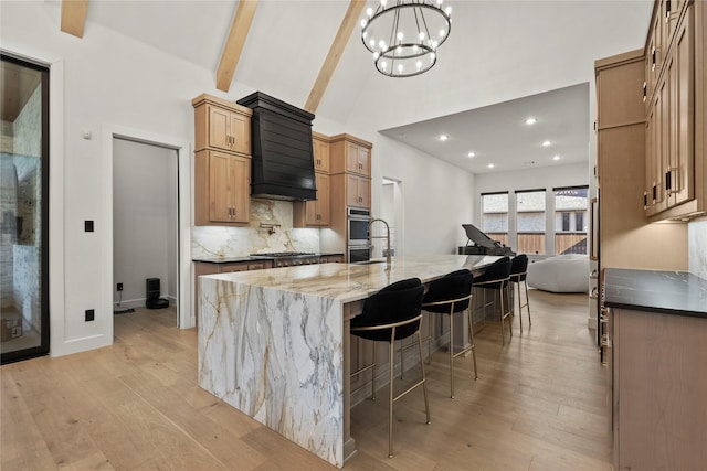 kitchen featuring appliances with stainless steel finishes, tasteful backsplash, light wood-type flooring, and beam ceiling