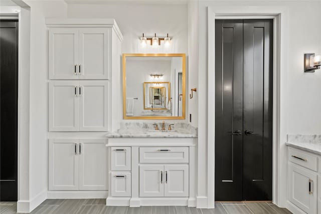 bathroom featuring vanity and baseboards