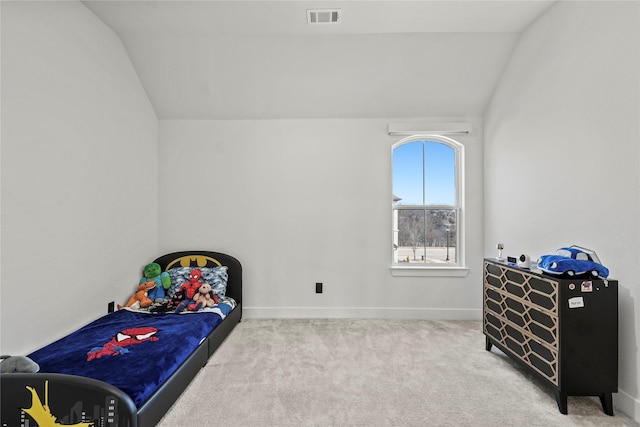 carpeted bedroom featuring baseboards, visible vents, and vaulted ceiling