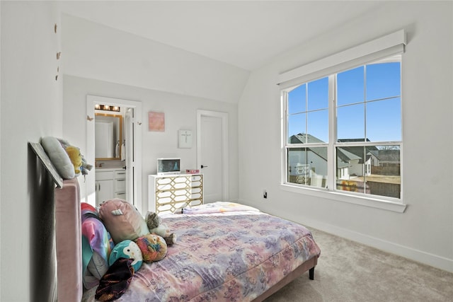 carpeted bedroom featuring baseboards and vaulted ceiling