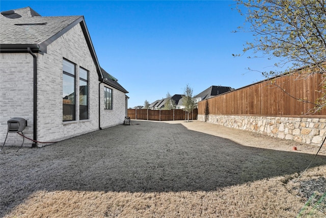 view of yard with a fenced backyard