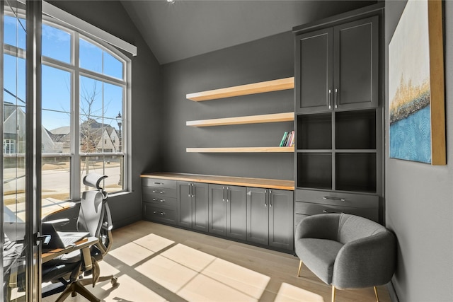 office area with lofted ceiling and light wood-style flooring