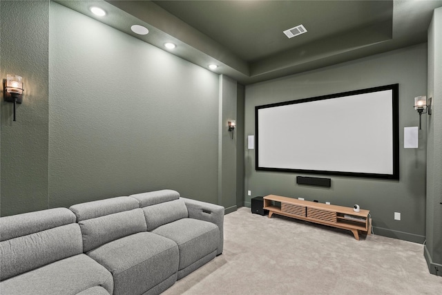 carpeted home theater with baseboards, visible vents, a textured wall, a tray ceiling, and recessed lighting