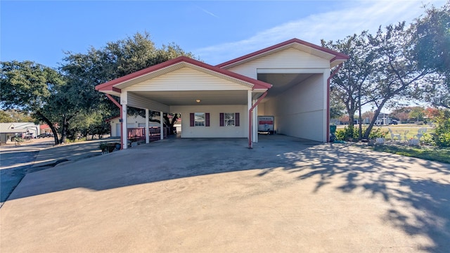 view of front of home with driveway and an attached carport