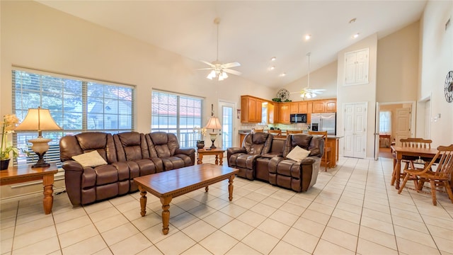 living area featuring a ceiling fan, high vaulted ceiling, and light tile patterned floors