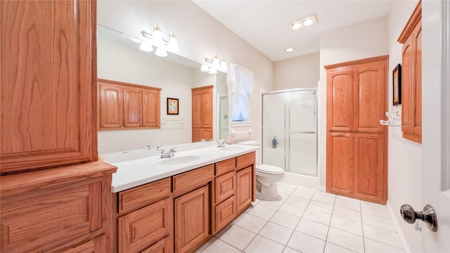 bathroom with double vanity, tile patterned flooring, a shower stall, and a sink