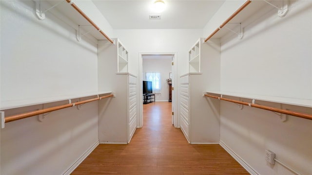 spacious closet featuring visible vents and light wood-style flooring