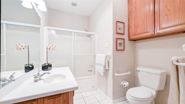 full bath featuring baseboards, toilet, shower / bath combination with glass door, tile patterned flooring, and vanity