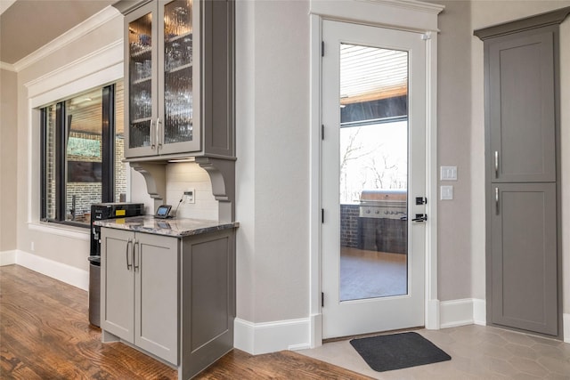 doorway to outside featuring dark wood-type flooring and baseboards