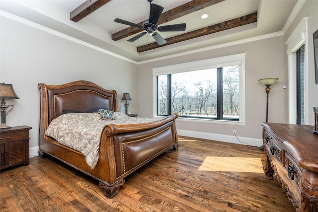 bedroom featuring wood finished floors, a ceiling fan, baseboards, a tray ceiling, and beamed ceiling