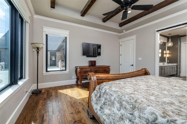 bedroom with a raised ceiling, crown molding, baseboards, and wood finished floors