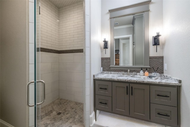 full bath featuring ornamental molding, a stall shower, vanity, and tile patterned floors