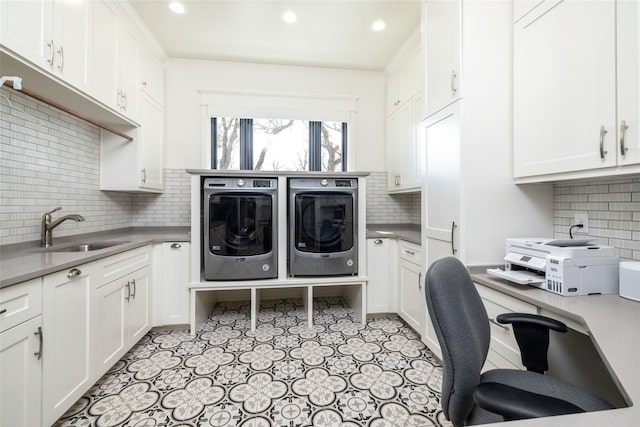 clothes washing area with recessed lighting, cabinet space, a sink, and separate washer and dryer