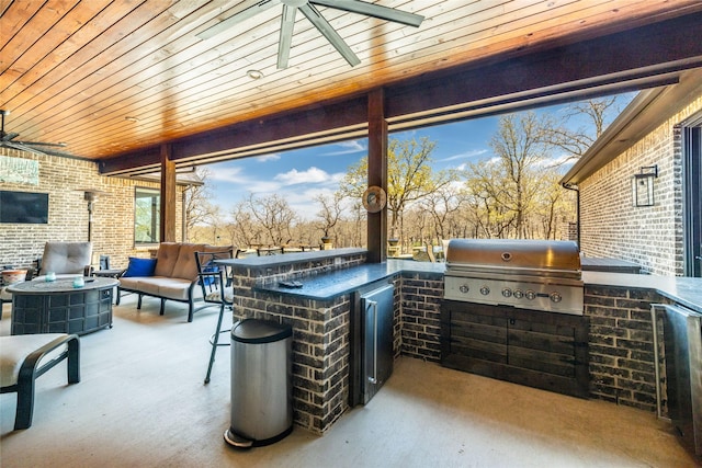 view of patio / terrace with ceiling fan, an outdoor hangout area, an outdoor kitchen, and area for grilling