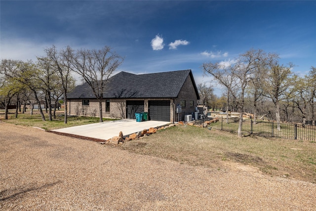 view of front of home with a garage, a front yard, fence, and driveway