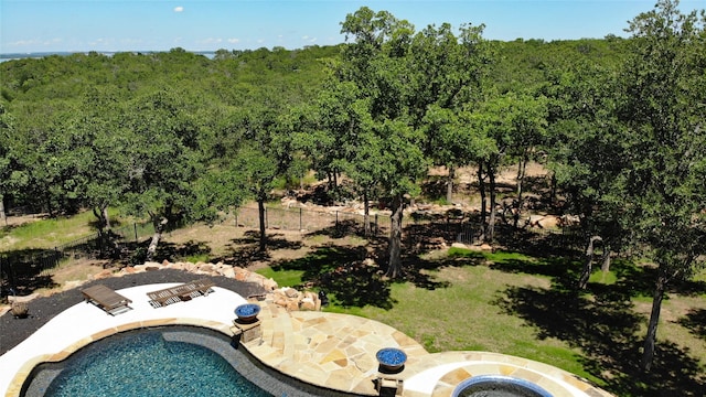 birds eye view of property featuring a view of trees