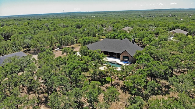 bird's eye view featuring a wooded view