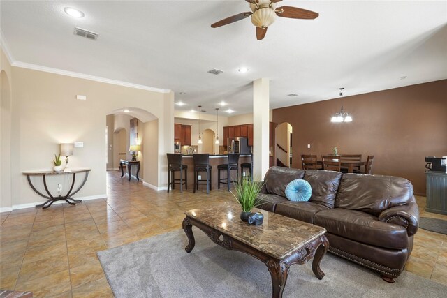 281 Crossbow Dr, Sunnyvale, TX 75182 - living room with arched walkways, ceiling fan, ornamental molding, light tile patterned floors, and a chandelier