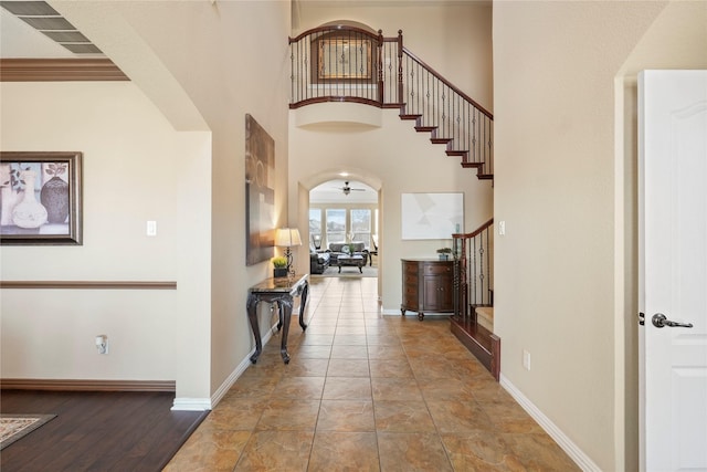 281 Crossbow Dr, Sunnyvale, TX 75182 - entryway featuring stairway, ceiling fan, arched walkways, and a towering ceiling