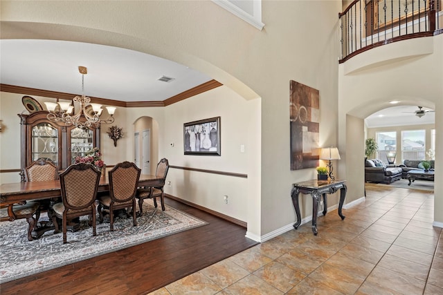 281 Crossbow Dr, Sunnyvale, TX 75182 - dining room with arched walkways, a chandelier, crown molding, wood finished floors, and a ceiling fan