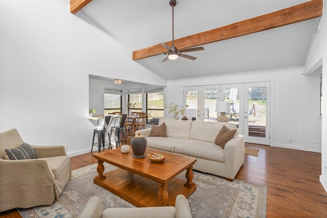 living area featuring french doors, plenty of natural light, beam ceiling, and wood finished floors