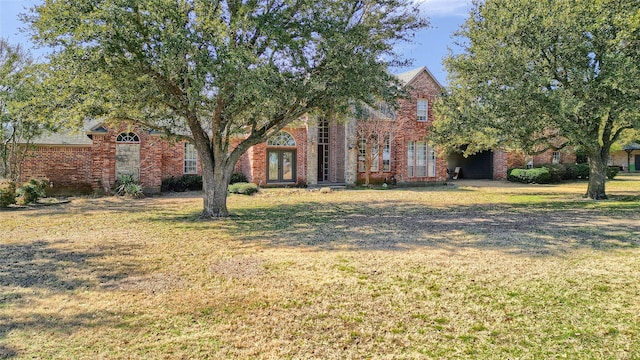 view of front facade with a front lawn and brick siding